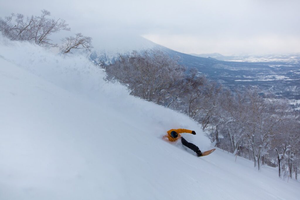 snowboarder riding powder in Japan
