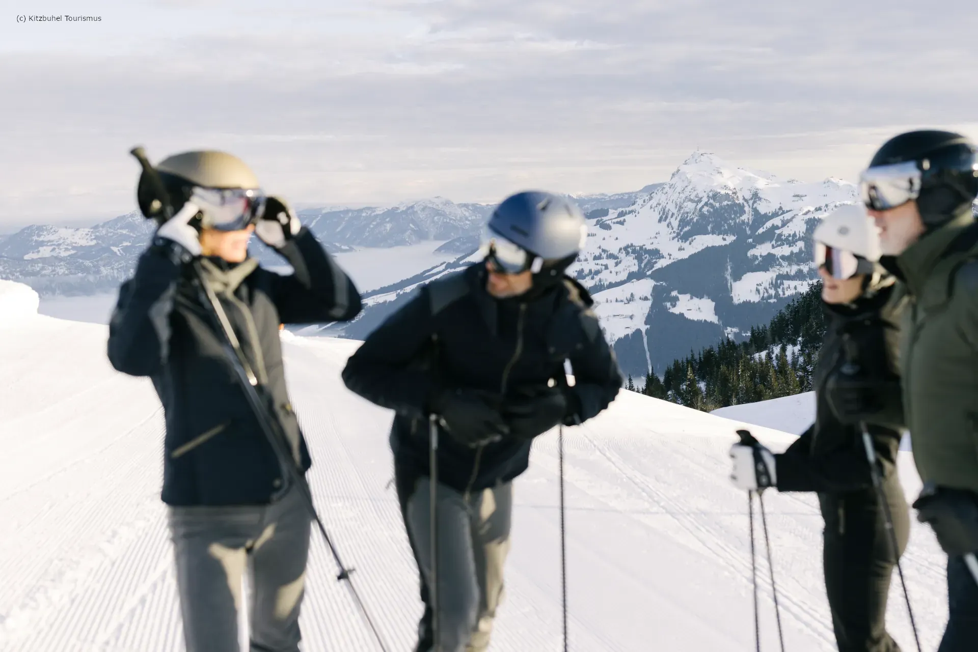 Skiers chatting atop Kitzbuhel ski resort
