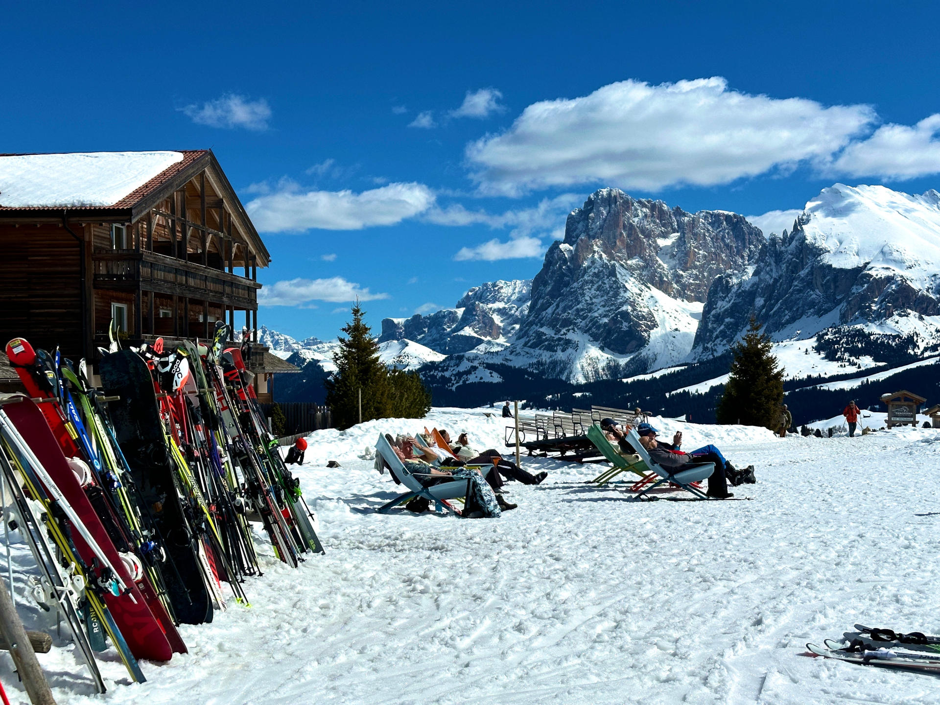 Sella Ronda-4 skiers lounging in the sun at Sella Ronda ski resort