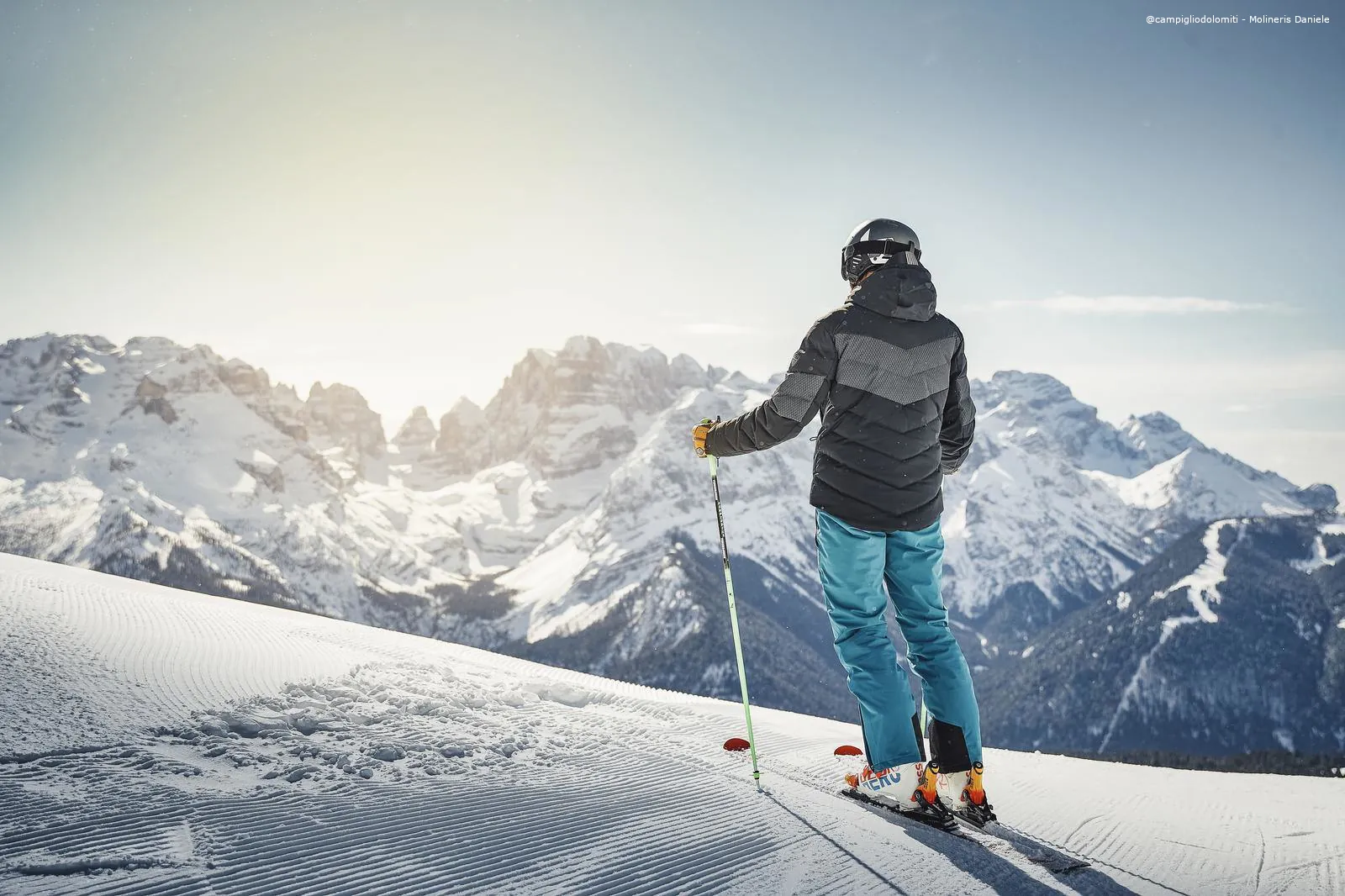 Skier standing atop the ski hill at Madonna di Campiglio