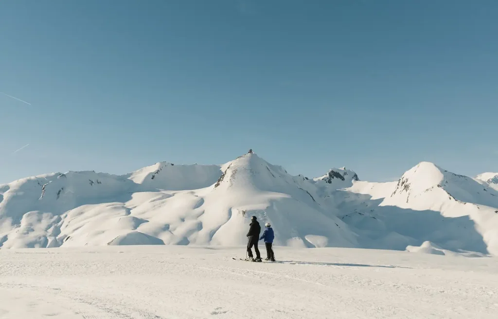 skiers atop a snow covered mountain in Peisey Vallandry