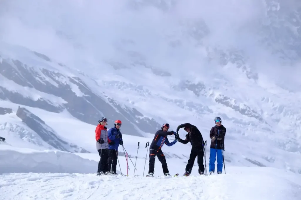 skiers atop a hill in Saas Fee