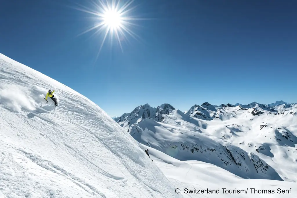 skier shredding the slopes in Andermatt on a sunny day