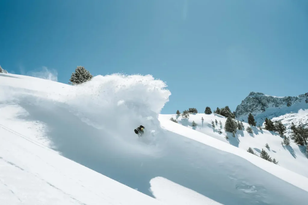 skier sending powder flying in Andorra