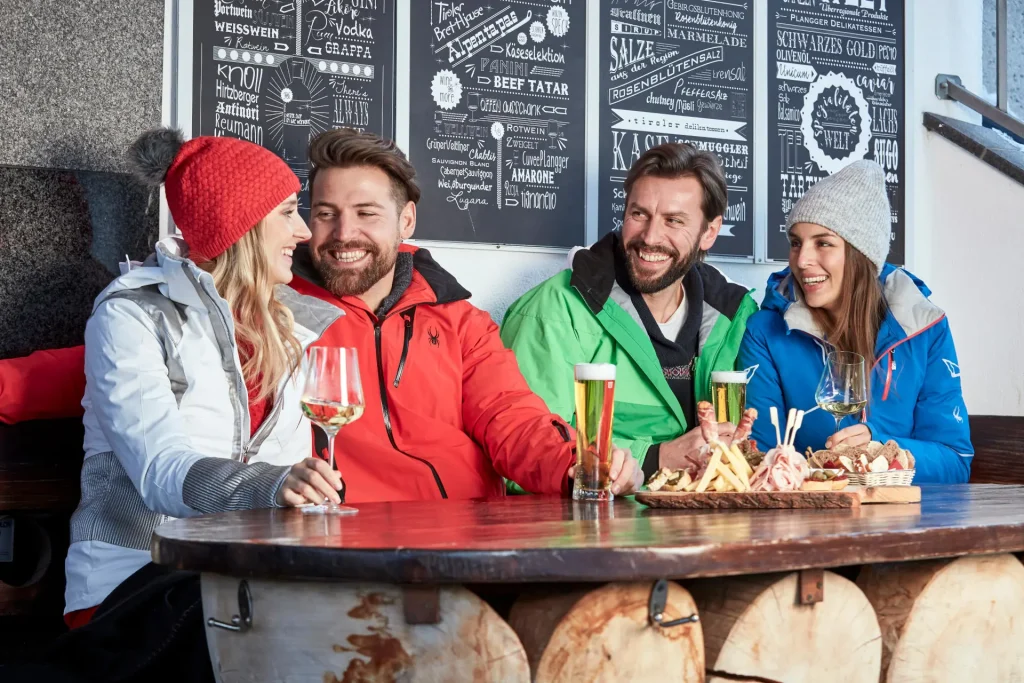 skiers enjoying apres-ski beverages and food