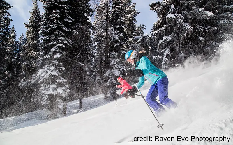 Kimberly 2 2 skiers descending a groomed run in Kimberly, BC