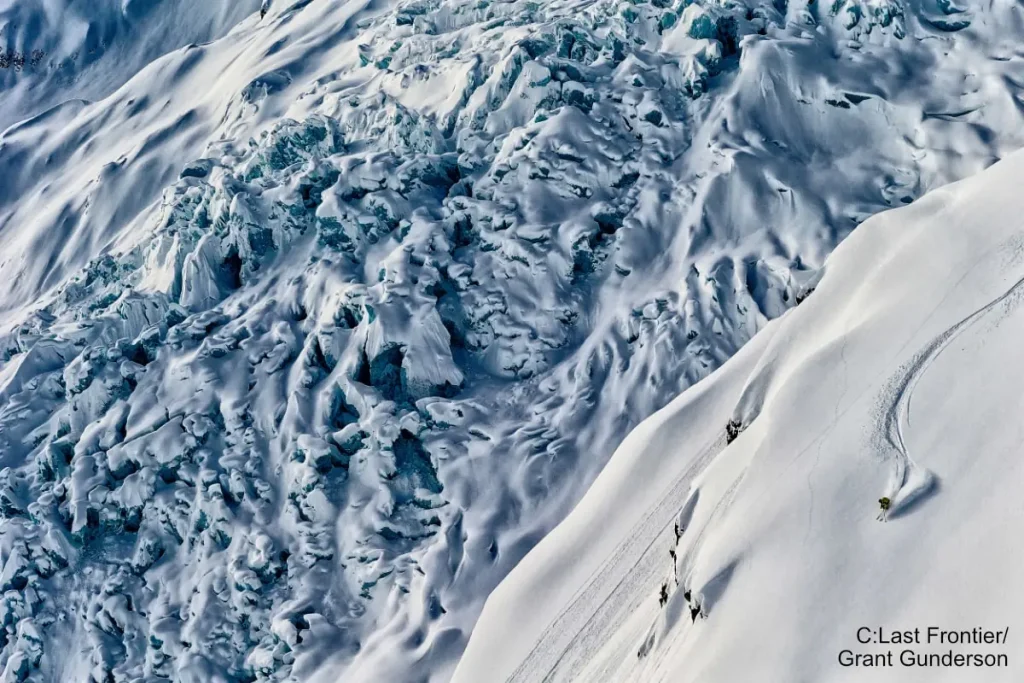Last_Frontier 3 skier on steep terrain with Bell 2 Lodge heliskiing