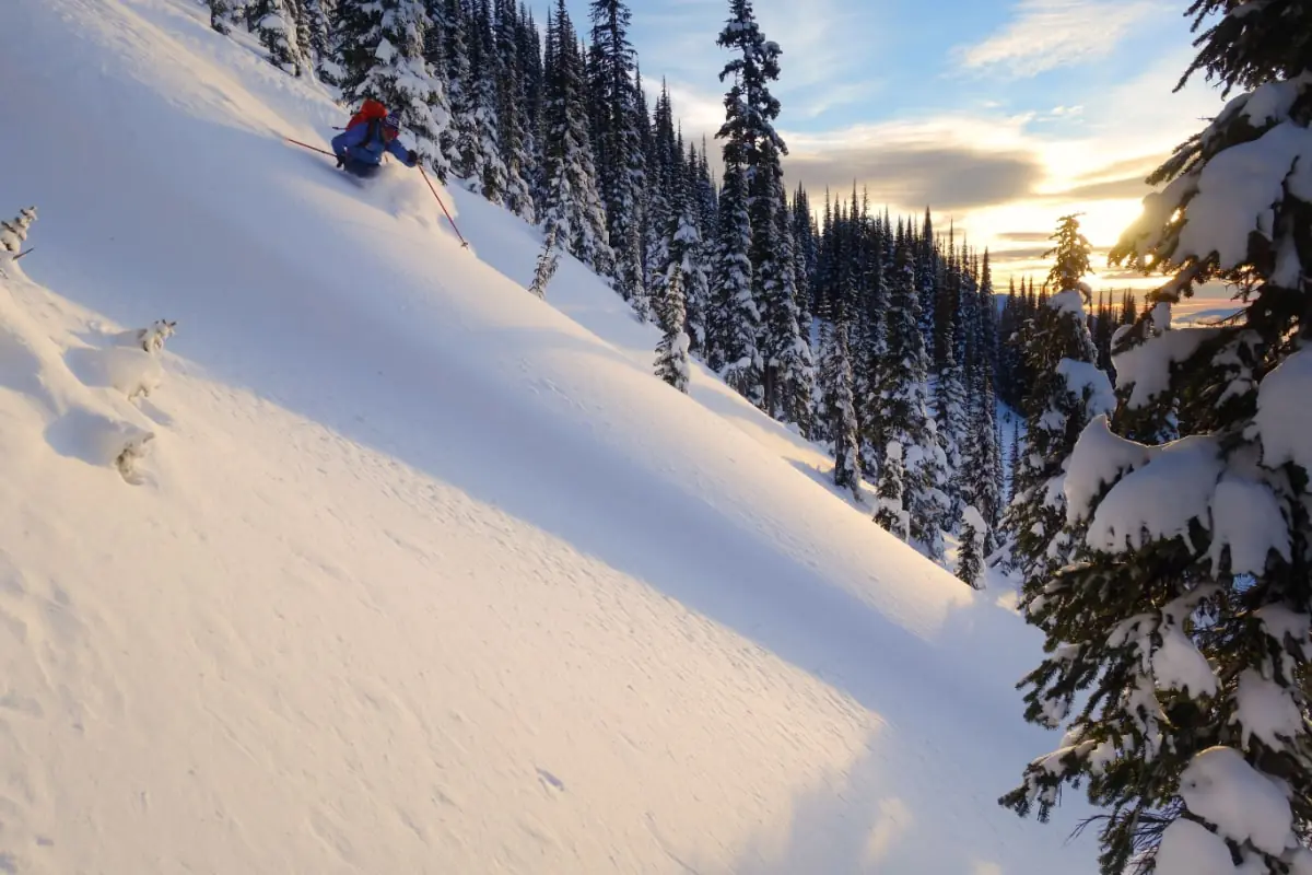 Powder Highway 4 sun setting on a skier in deep powder