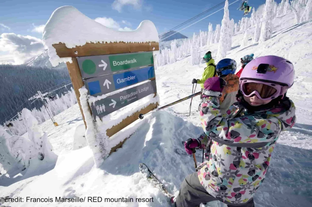 Red Mountain 1 young skiers check out a sign atop Red Mountain Ski Resort