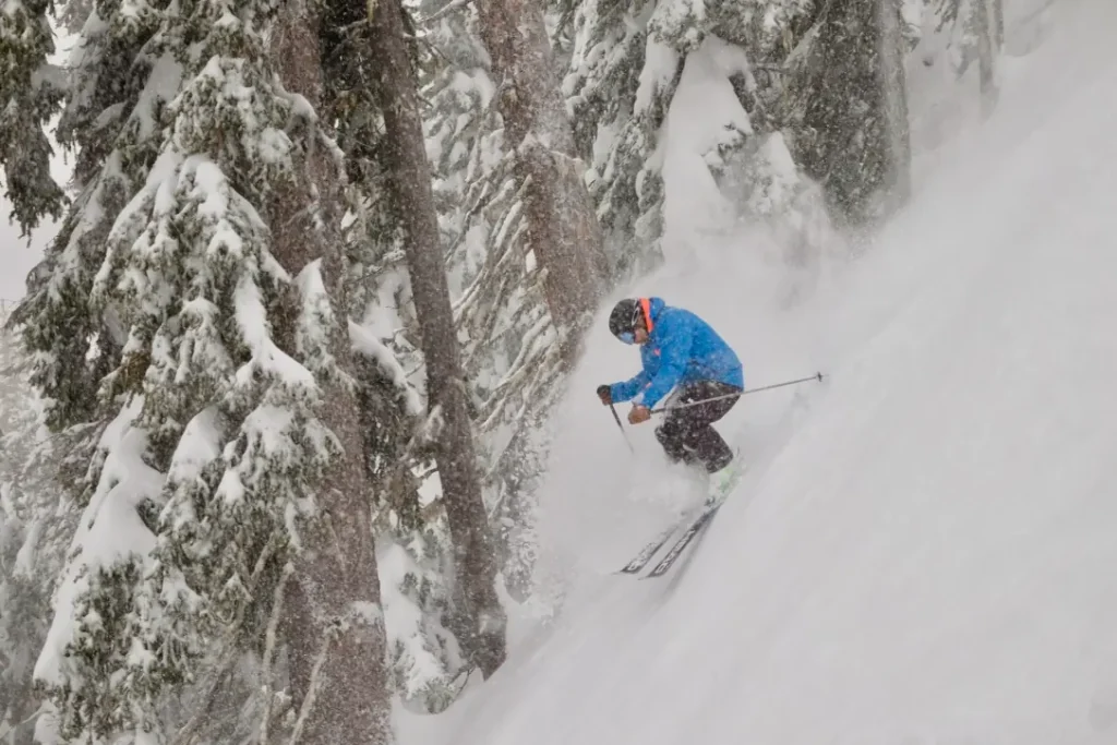 skier in deep powder on a steep hill in Revelstoke