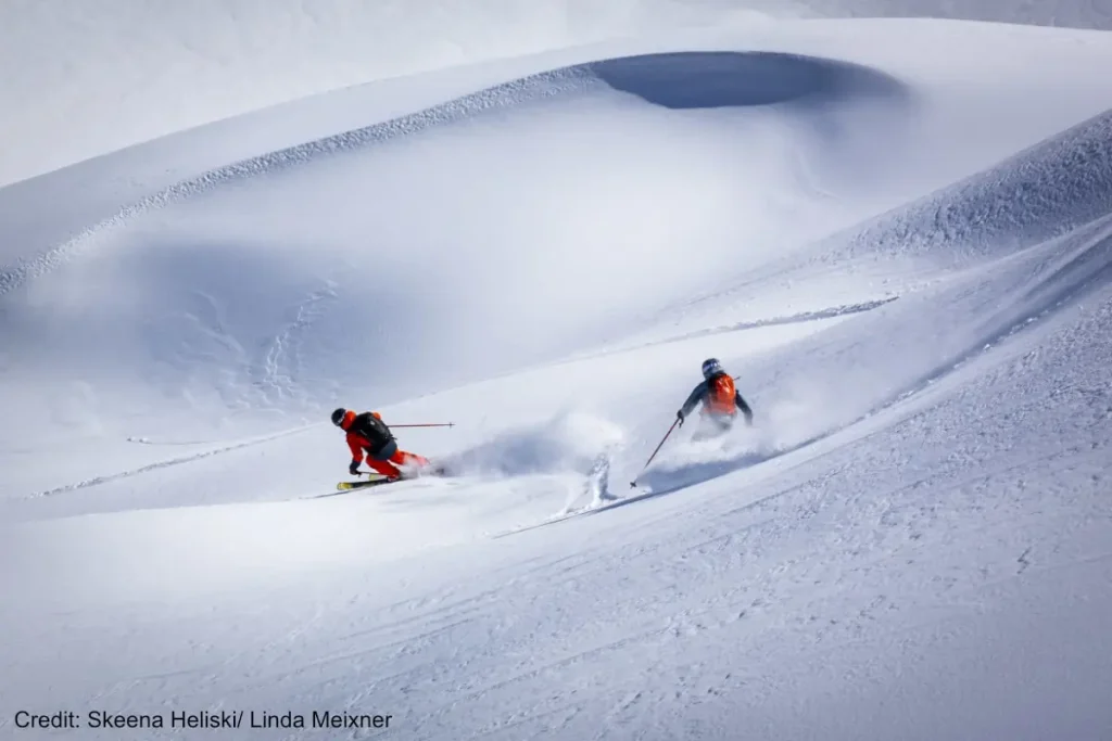 Skeena heli 4 heli skiers in deep powder with Skeena Bearclaw tour