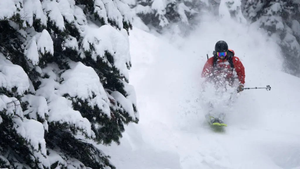 White-Grizzly-1 skier bursting through powder at White Grizzly lodge
