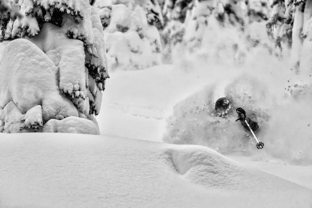 heli skier navigating deep powder
