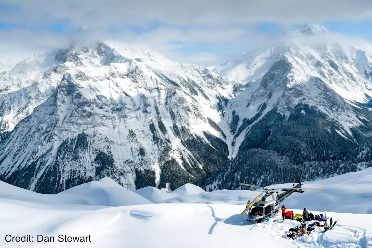 revelstoke-heliski 2 helicopter landing in deep snow to drop off skiers near Revelstoke