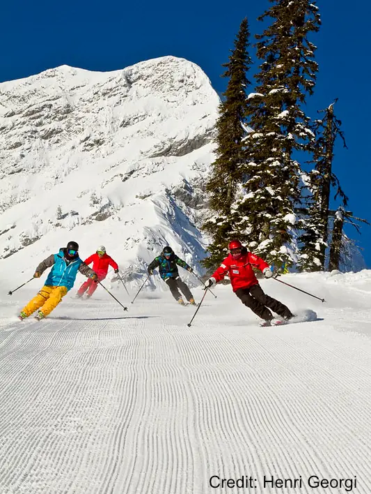 skiers group of skiers on a groomed run
