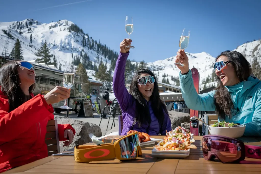 Palisades 5 women raising a glass of wine on a sunny day in Palisades ski resort