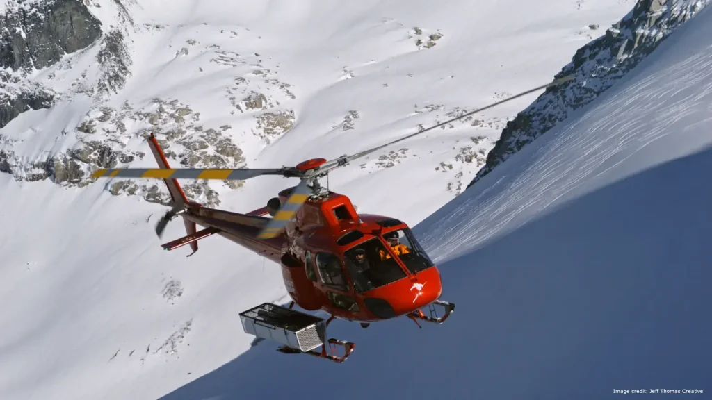 Helicopter carrying skiers into the mountains