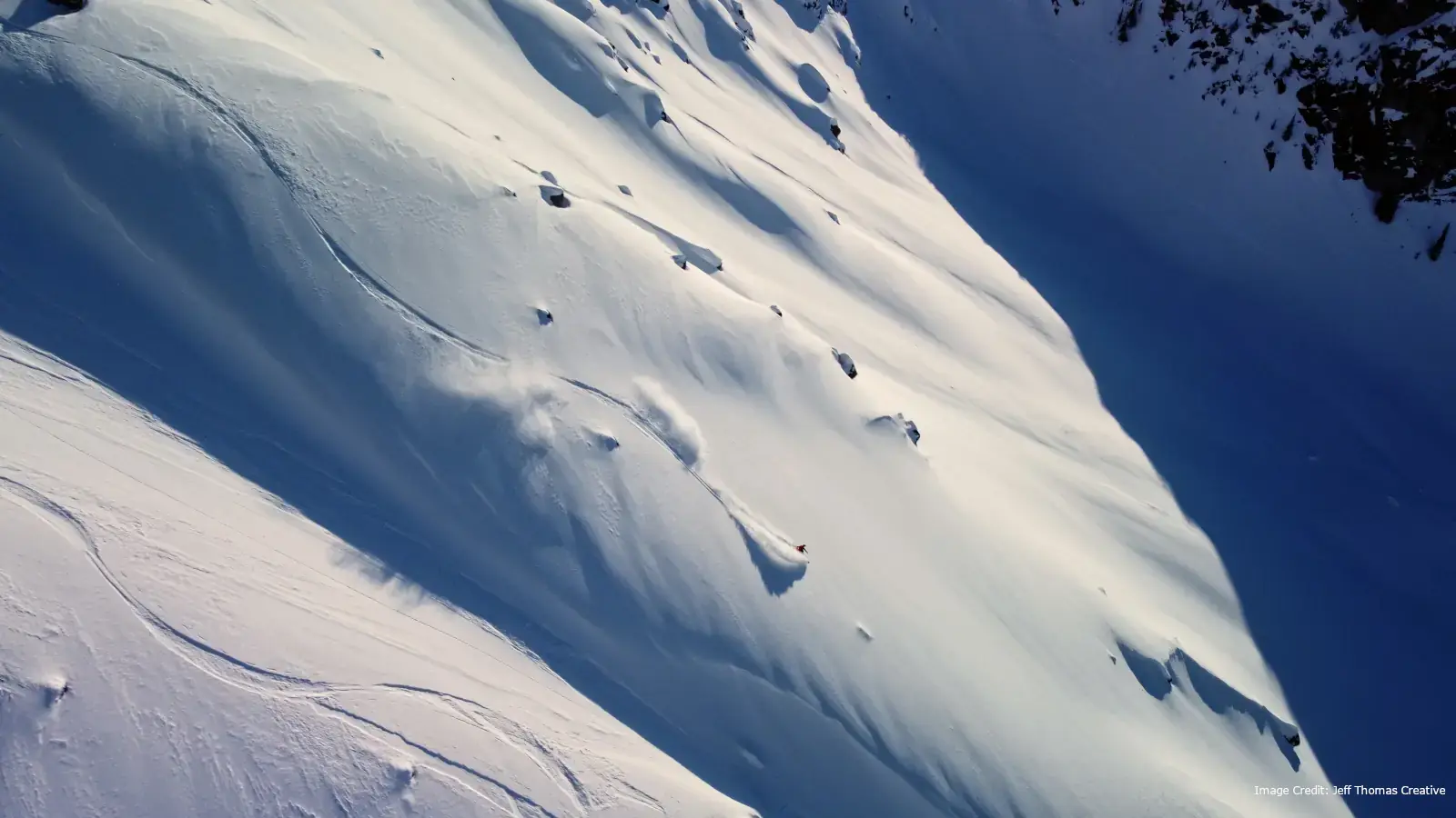 heli skiers getting turns on fresh powder at Whistler