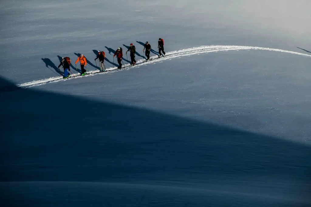 ski group traversing snowfield near Whitecap Alpine Adventure lodge