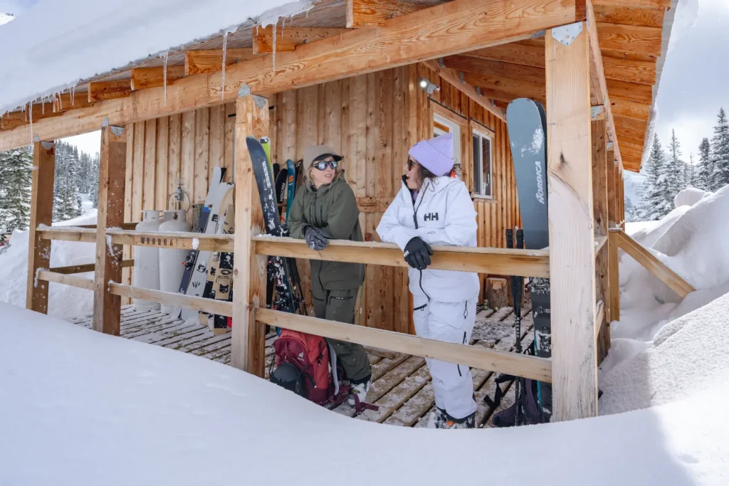 skiers relaxing outside lodge area at Whitecap Alpine Adventure lodge