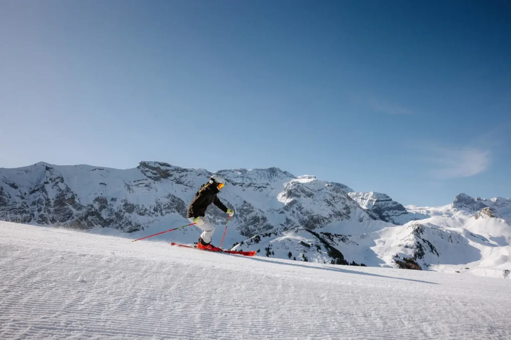 skier descending a groomed run in Adelboden