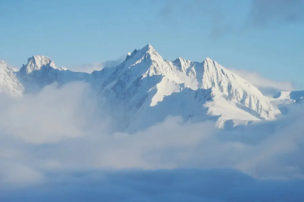 snow covered peaks poking out above the clouds in La Plagne