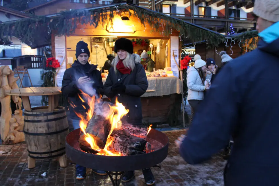 guests standing around an outdoor firepit in Madonna di Campiglio