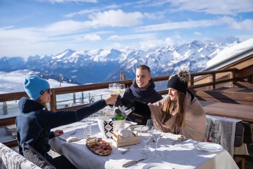 enjoying a glass of wine on the balcony of Madonna-Di-Campiglio ski resort