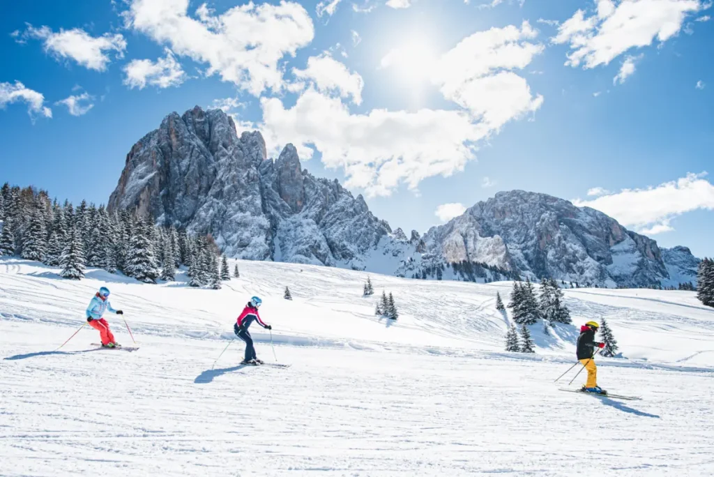 group of skiers on a groomed run in Sella Ronda