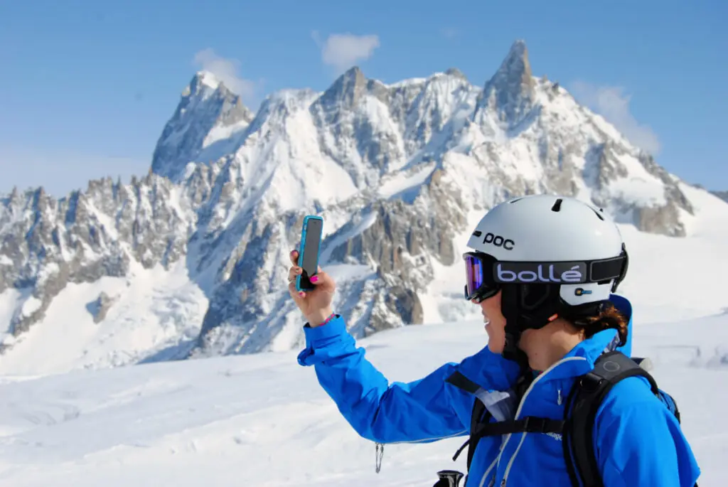 skier taking a pic of the mountains in Chamonix