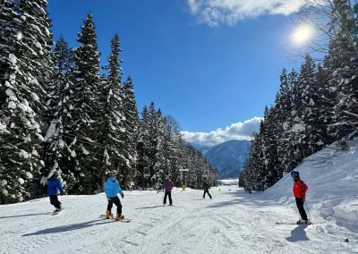 skiers on an easy groomed slope in Hakuba, Japan